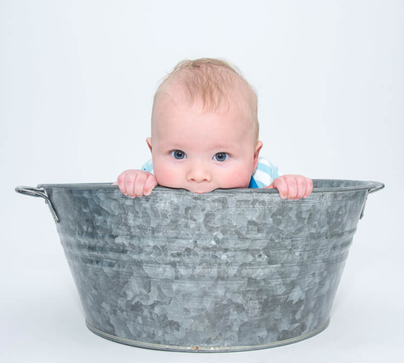 Shot of baby bitting tub by Nick Ford Photography