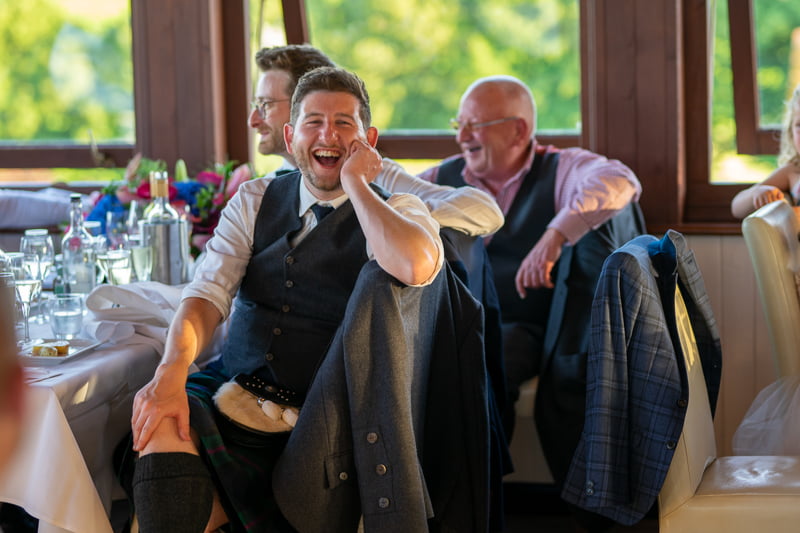 Photo of wedding guests laughing at speeches by Nick Ford Photography