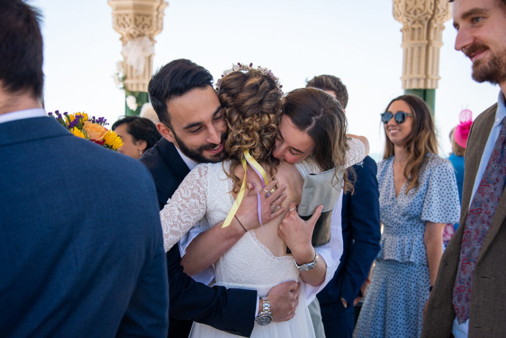 Bride hugging wedding guests after ceremony by Nick Ford Photography