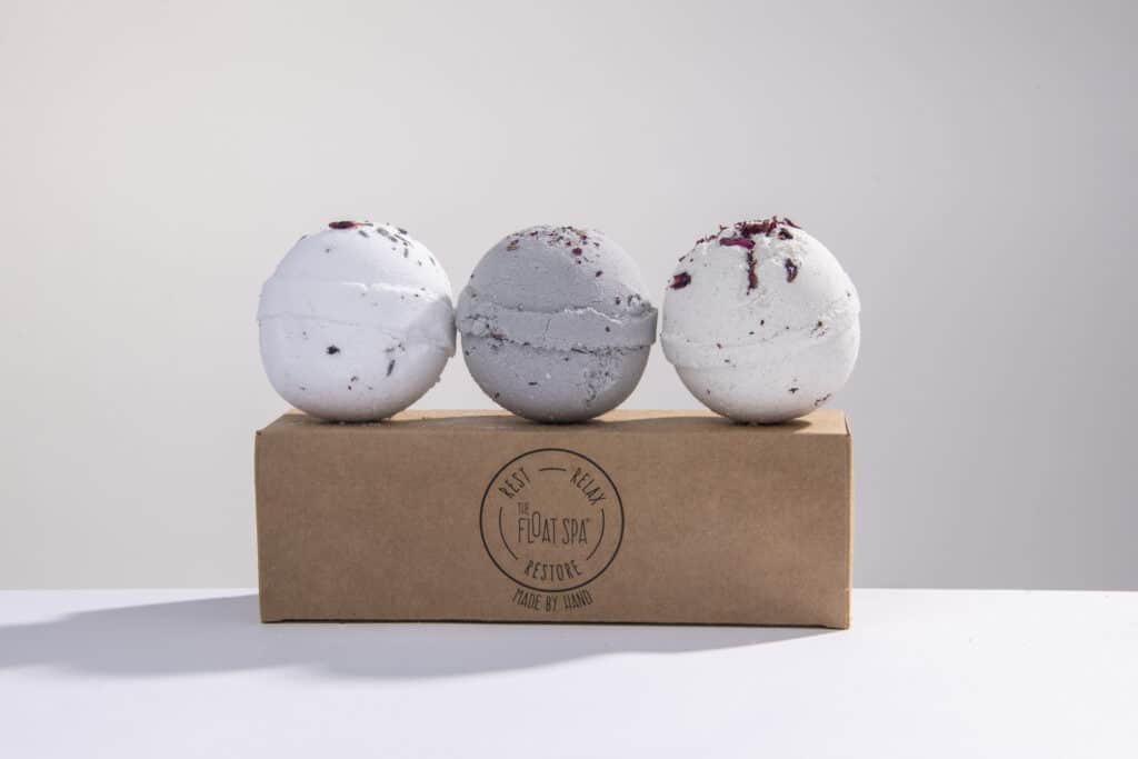 Simple product photography of three bath bombs on their box on a white backdrop by Nick Ford Photography