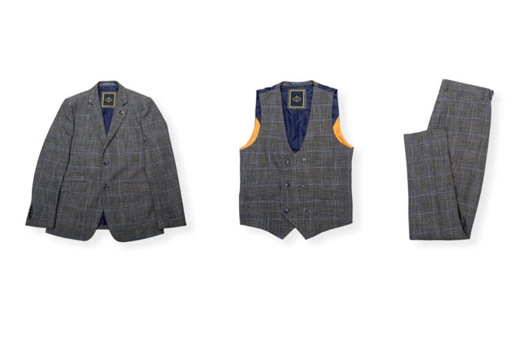 Suit jacket, waistcoat, and trousers displayed neatly next to each other on a white background, showcasing a coordinated and polished ensemble with a sharp, tailored fit.