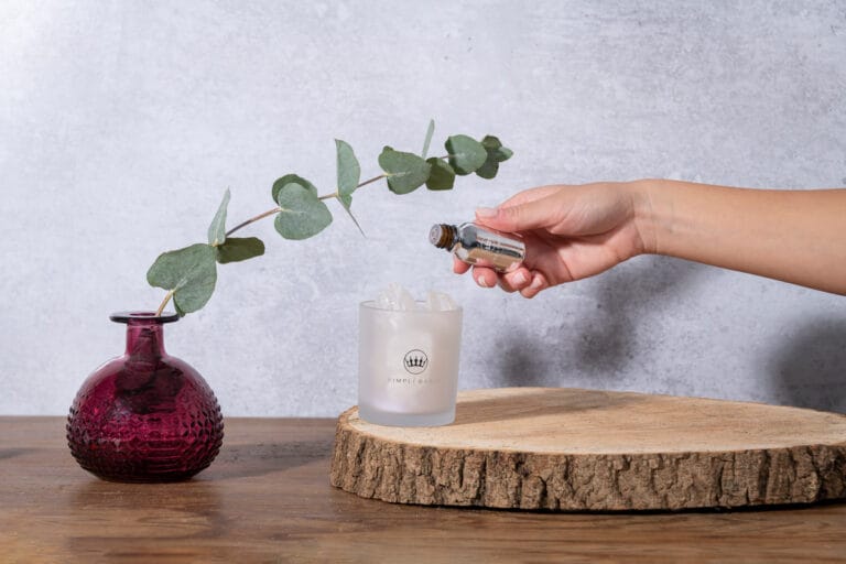 Hand model dripping essential oils onto an oil diffuser, captured in a serene moment, highlighting the soothing process and the elegant design of the diffuser.