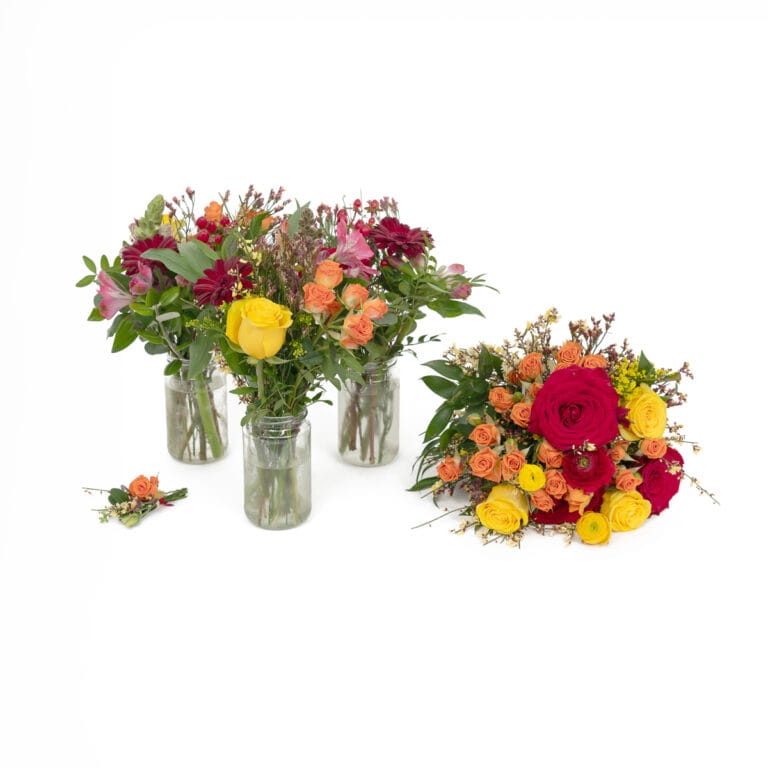 Group shot of three flower bunches in vases, a bouquet laid beside them, and buttonhole flowers next to it, all set against a simple white background to showcase the floral arrangements and elegant wedding details.