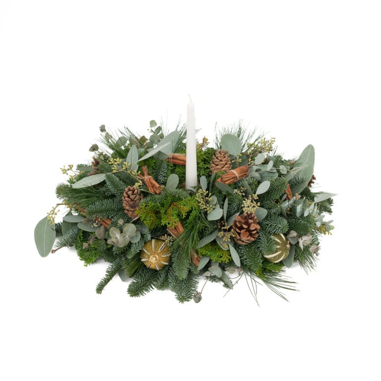 Candle stick placed inside an ornate wreath, set against a simple white background, emphasising the intricate details and elegant design.